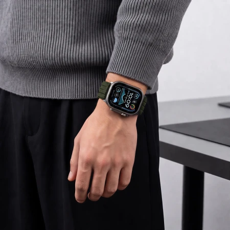 Mężczyzna w szarym swetrze – zielony pasek Nylon Sport z Apple Watch na nadgarstku